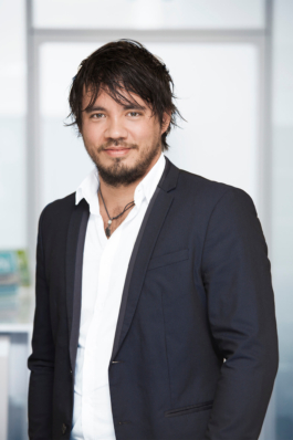 Businessportrait eines Angestellten im Bereich Human Resources vor hellem Bürohintergrund.